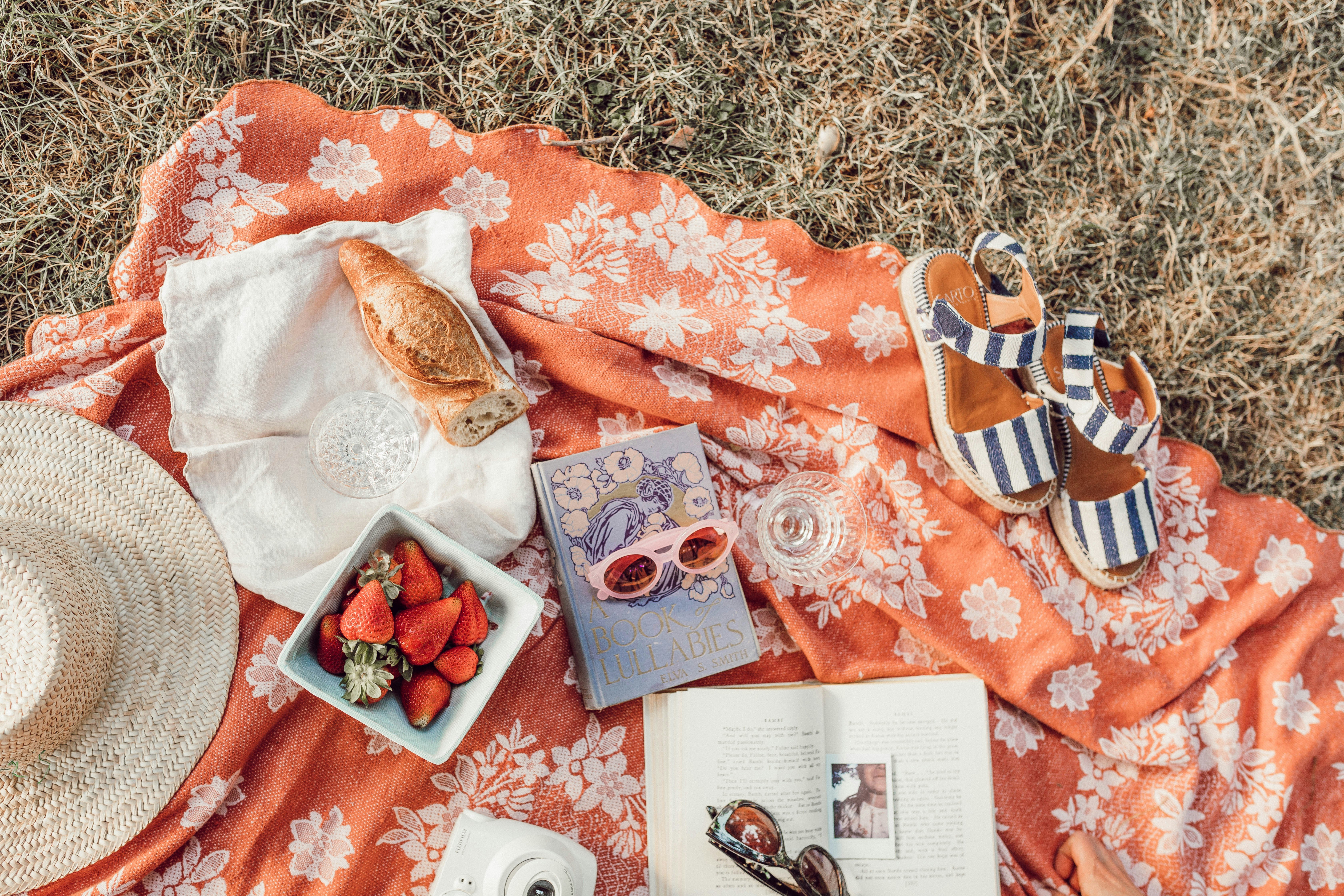 top angle photography of strawberries beside book